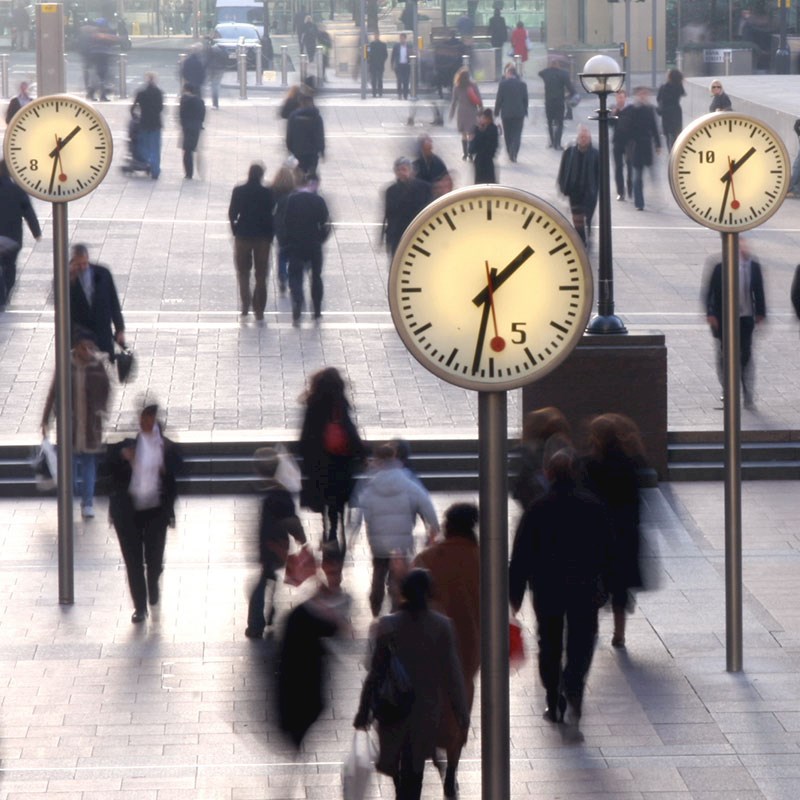 People walking near clocks