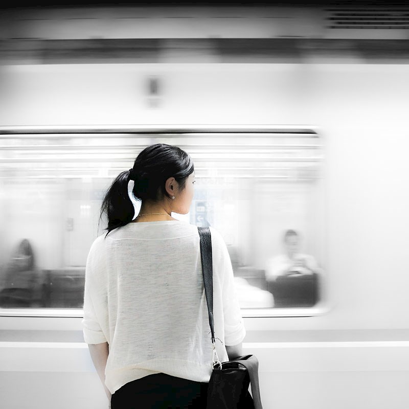Woman facing a passing subway